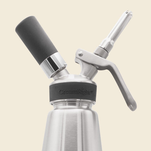 Closeup of CreamRight stainless steel whipped cream dispenser
